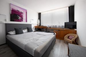 Postel nebo postele na pokoji v ubytování hogh Hotel Heilbronn + 37 fotografií