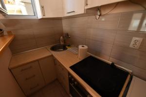 a small kitchen with a sink and a stove at Apartman Poezija in Bajina Bašta