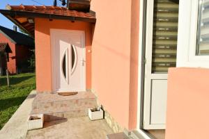 a door on the side of a house at Apartman Poezija in Bajina Bašta