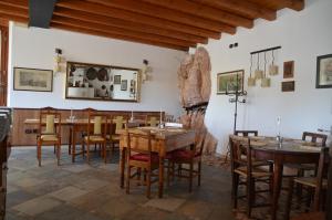 a dining room with wooden tables and chairs at Agriturismo Corte Marani in Badia Calavena