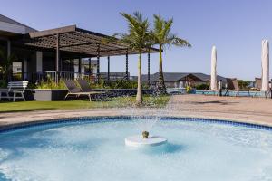 a swimming pool with a fountain in the middle at 427 Ballito Hills - Lovely 3 bedroom apartment in Ballito
