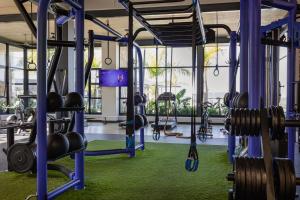 a gym with blue beams and lots of weights at 427 Ballito Hills - Lovely 3 bedroom apartment in Ballito