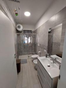 a bathroom with a sink and a toilet and a shower at CASA VACANZE NANA' VIESTE in Vieste +35 photos