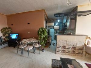 a living room with a table and a kitchen at شقة اطلالة الأهرامات in Cairo