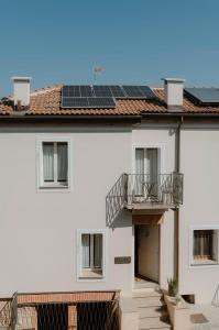 a white building with solar panels on the roof at Appartamento Lìelà in Millesimo