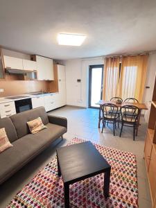 a living room with a couch and a table at Casa Zara - cozy home in the heart of Barga in Barga