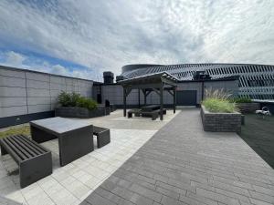 a patio with benches and a pavilion in front of a building at Tammer Huoneistot - City Suite 6 - Best Location & Great Amenities in Tampere