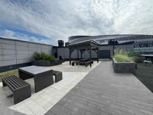 a patio with benches and a pavilion in front of a building at Tammer Huoneistot - City Suite 6 - Best Location & Great Amenities in Tampere