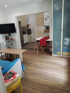 Una sala de estar con una mesa y un comedor. en Charmante petite maison à 15 min de Paris, en Villemomble