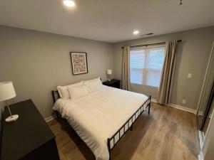 a bedroom with a bed and a table and a window at Aksarben View One Bedroom in Omaha