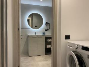 a bathroom with a sink and a mirror at Villa Regina - Lake Ledro Apartments in Ledro
