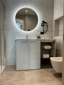 a bathroom with a sink and a mirror at Villa Regina - Lake Ledro Apartments in Ledro +41 photos