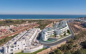 an aerial view of a large white building near the ocean at 22 Aura-Piscina 3 Vistas al mar in Gran Alacant