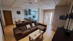 a living room with a couch and a table at Lo de Joel in Els Muntells