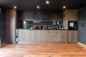 a kitchen with wooden cabinets and a counter top at Samana Vayu in Poole