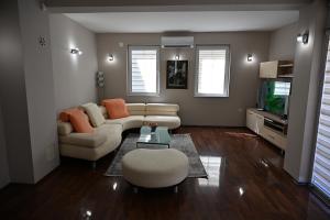 a living room with a couch and a tv at Villa Continental in Bitola