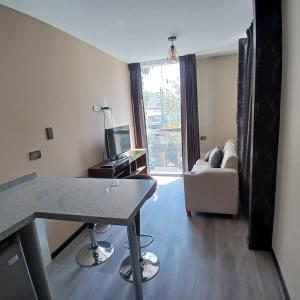 a living room with a table and a couch at Aparments Av La Paz in Arequipa