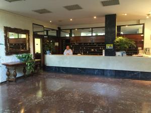 a woman standing at the counter of a restaurant at Skol Apartments Marbella in Marbella +173 photos
