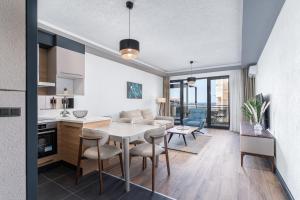 a kitchen and living room with a table and chairs at Vista Seaview in Sveti Stefan
