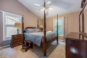 a bedroom with a bed and a ceiling fan at Cozy 3Br Lake Retreat with Backyard & Fire Pit in Mineral