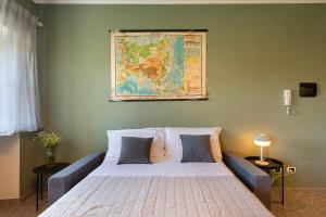 a bedroom with a large bed with a map on the wall at Casa del Corso in Novi Ligure +8 photos