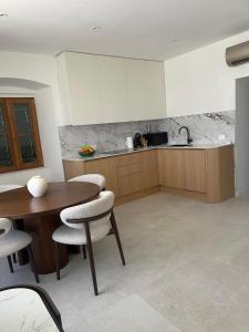 a kitchen with a table and chairs and a sink at Old town Pjaca Makarska in Makarska