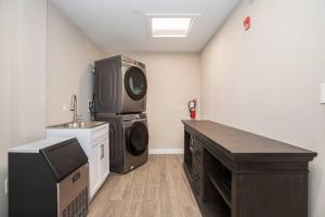 a laundry room with a sink and a washing machine at Private Room, Kitchen & Bath 1 in Bradenton
