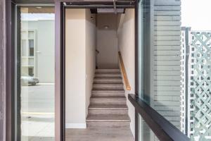 a staircase in a building with a glass door at Private Room, Kitchen & Bath 1 in Bradenton +2 photos