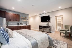 a bedroom with a large bed and a flat screen tv at Private Room, Kitchen & Bath 1 in Bradenton
