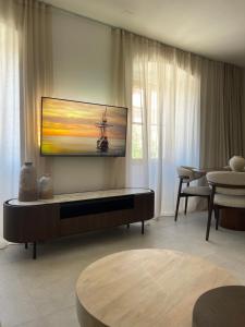 a living room with a tv on the wall at Old town Pjaca Makarska in Makarska