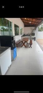 a large living room with a table and a table at Casa 4 quartos in Camaçari