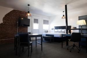a bedroom with a bed and a table and chairs at American Hotel in Los Angeles