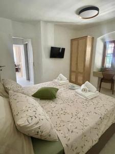 a bedroom with a bed with towels on it at Old town Pjaca Makarska in Makarska