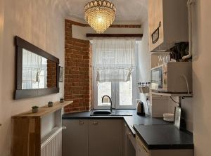 a small kitchen with a sink and a window at Crystal Apartament in Lublin