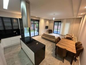 a living room with a table and a couch at Villa Anı in Antalya