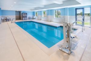 a large pool with blue water in a building at Holiday Inn Express - Colorado Springs - First & Main by IHG in Colorado Springs