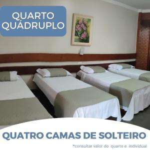 a group of four beds in a room at Hotel Master Cuiabá in Cuiabá +10 photos