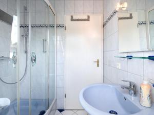 a white bathroom with a sink and a shower at Apartment in Sallneck near Nonnenmattweiher Lake in Sallneck +24 photos