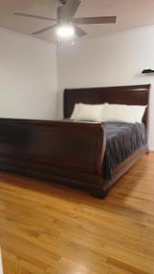 a bed in a room with a ceiling fan at Evergreen Estates 3-Bedroom Private in Fayetteville