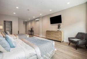 a bedroom with two beds and a television on the wall at Private Room, Kitchen & Bathroom 2 in Bradenton