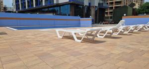 a row of white picnic tables on a patio at Black Sea Line in Gonio
