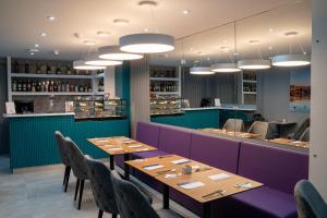 a restaurant with tables and chairs and a bar at The Republic Boutique Hotel in Valletta