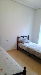 a bedroom with two beds in a room at Appartement in Nador in Nador