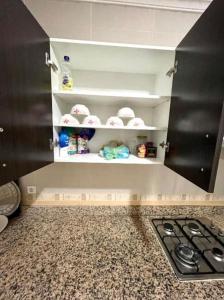 a kitchen with a stove and some shelves at Appartement in Nador in Nador