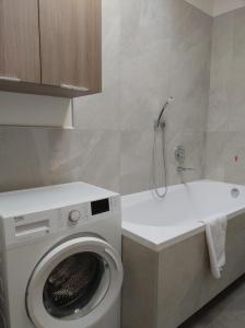 a bathroom with a washing machine and a sink at cairoli7novate-mansarda in Novate Milanese +19 photos