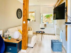 a living room with a white couch and a tv at Résidence B20-perros Guirec - Maison avec terrasse près du port de Perros-Guirec MAE-3764 in Perros-Guirec