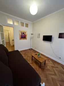 a living room with a couch and a table at Hotel Paris in Río Gallegos