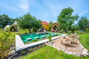 a backyard with a swimming pool and a house at deichkind country loft in Achim