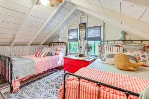 a bedroom with two beds and a red dresser at about 1 Mi to Dtwn Grand Haven Lake Michigan Cabin in Grand Haven