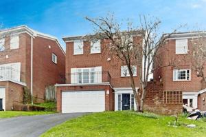 a large brick house with a white garage at Spacious 5 Bedrooms Family Detached House in Purley 23 min to Central London in Purley